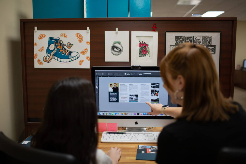 Jenny Altman and Bethany Aiken review a design project at Trevett's.